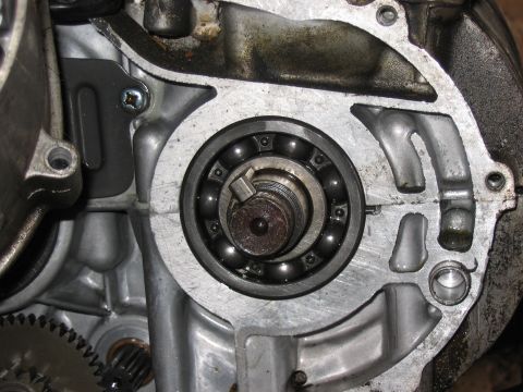 1997 Yamaha YT60 Tri-Moto - Engine casing with a ball bearing and gears visible, suggesting internal mechanical components.