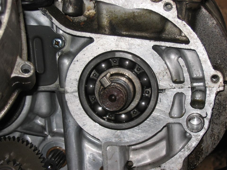 Exposed crankshaft ball bearing in an opened aluminum engine crankcase