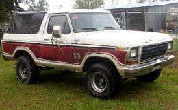 1979 Ford Bronco - This 1978 Ford Bronco is parked on a grassy area with a chain-link fence in the background.