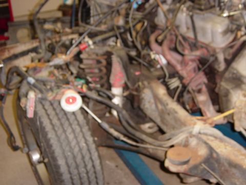 1991 Ford Bronco - Blurry picture of the wiring, brakes, and plumbing on the left framerail.