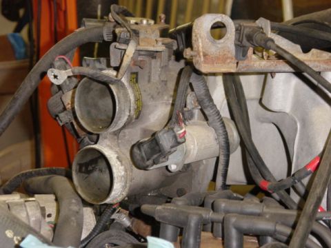 1991 Ford Bronco - Throttle body. My manifold was so thoroughly coated with combustion byproducts and blowby via the PCV, you probably wouldn't want to light…