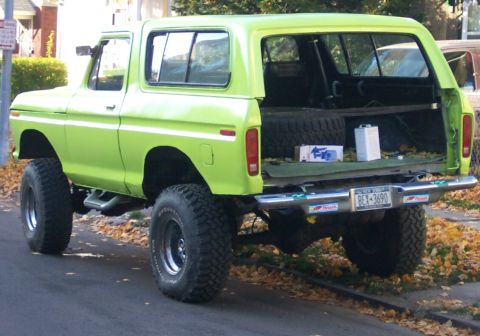 1978 Ford Bronco - This lime green 1978 Ford Bronco is viewed from the rear, showing its lifted suspension and large off-road tires.