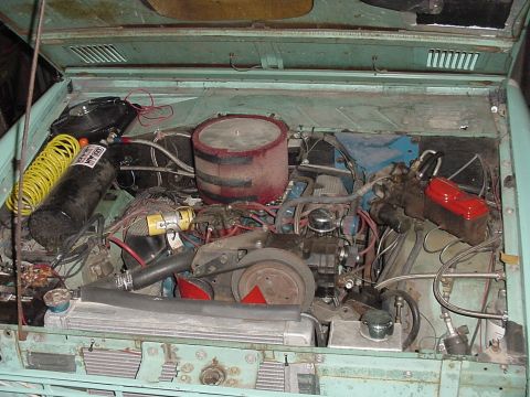1969 Ford Bronco - Engine bay of a 1969 Ford Bronco, showing the V8 engine and an added air compressor tank.