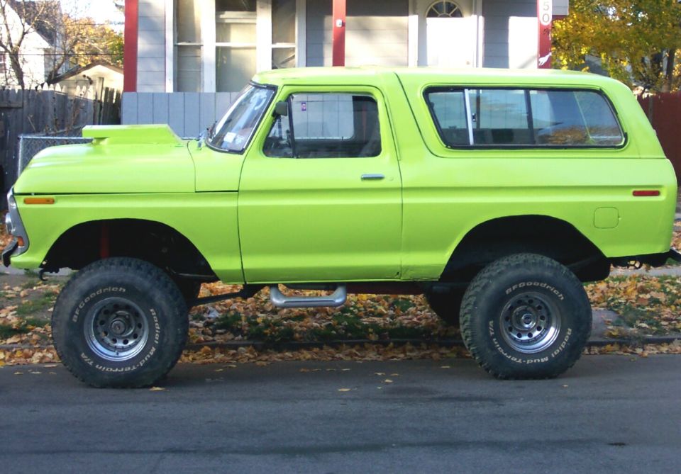 Lime green 1978 Ford Bronco side view with hood scoop and lifted suspension