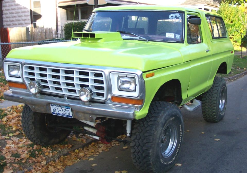 Lime green lifted SUV with a scoop on the hood. License plate reads BEX-3690