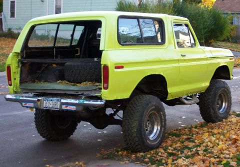 1978 Ford Bronco - This 1978 Ford Bronco features a lifted suspension, large off-road tires, and a spare tire mounted inside the cargo area.