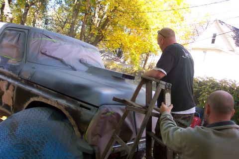 1978 Ford Bronco - Two men are working on the body of a 1978 Ford Bronco, preparing it for a new paint job.