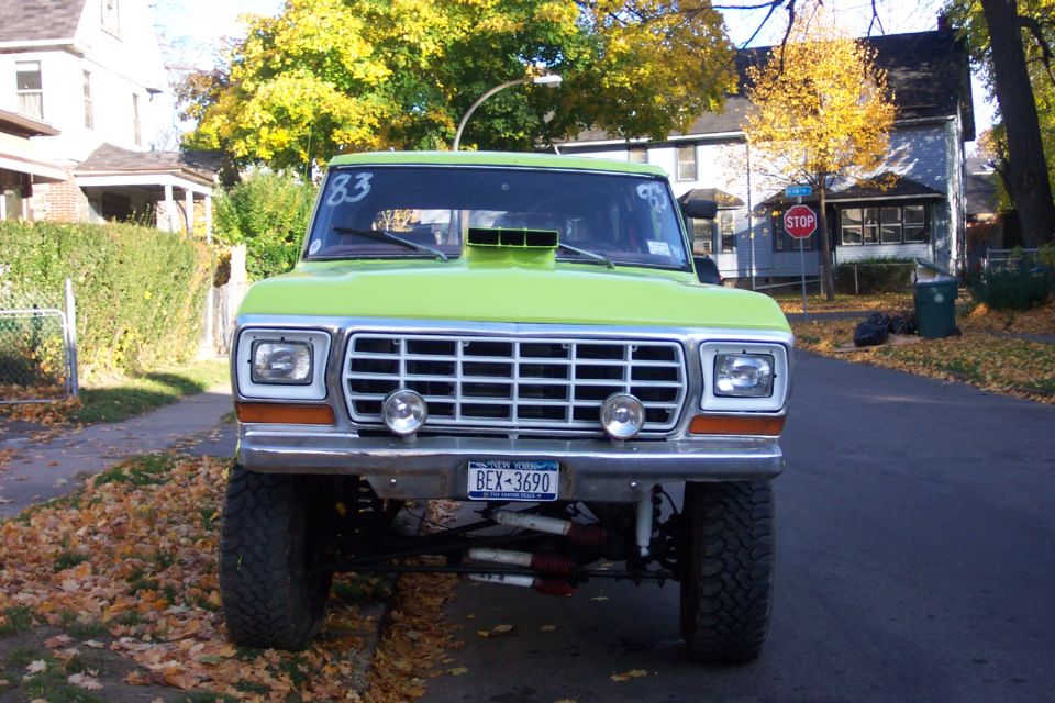 Lime green 1978 Ford Bronco front view with scoop on hood and aftermarket wheels