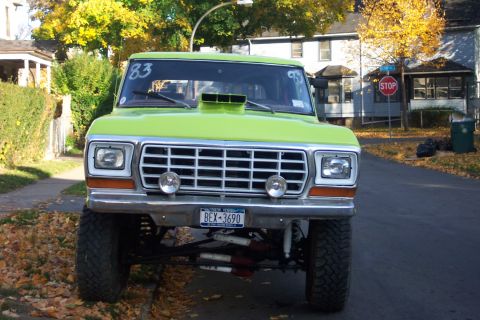 1978 Ford Bronco - Front view of a lifted 1978 Ford Bronco with a prominent hood scoop and custom grille.