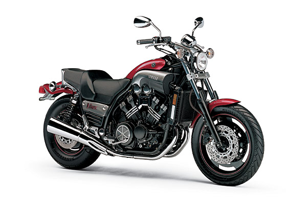 Red and black Yamaha V-Max motorcycle, front 3/4 view on white background