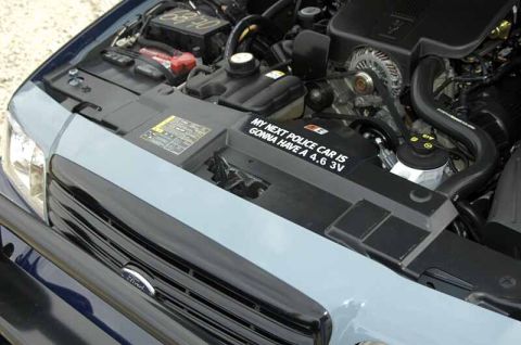 2000 Ford Crown Victoria - Engine bay of a 2000 Ford Crown Victoria, a custom sticker about its engine.