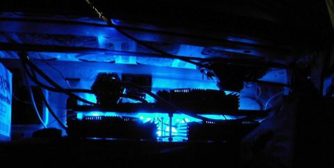 1985 Ford LTD Crown Victoria - Underbody neon lights illuminate the underside of a vehicle, with visible wiring and a box labeled 'OXON'.