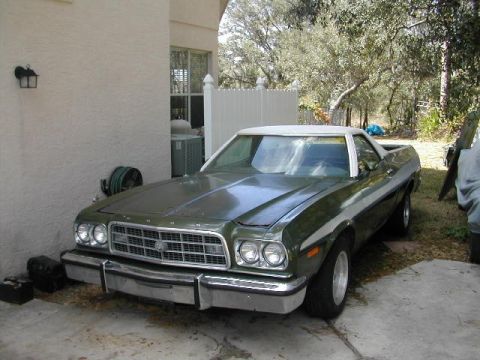 1973 Ford Ranchero - Green 1973 Ford Ranchero with a white vinyl top and side trim is parked outside a house.