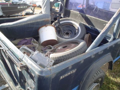 1981 Ford Bronco - bed, BW tranny, 2 tires with rims seat and a metal bucket.
