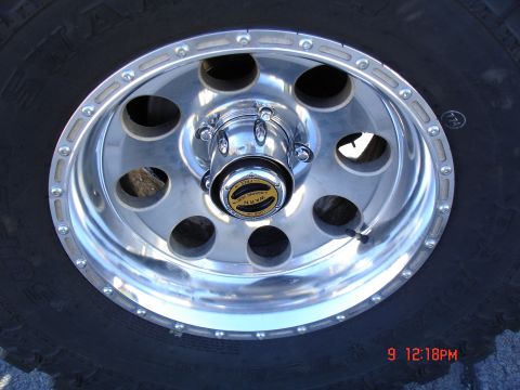 1979 Ford Bronco - Close-up of a vehicle's wheel and tire, showing a Warn locking hub cap.