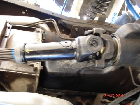 1979 Ford Bronco - Underside view of a vehicle's driveshaft and U-joint assembly.