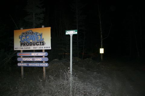 2003 Jeep TJ - Nighttime view of directional signs for Alaska Gravel Products and the Caudill street sign.