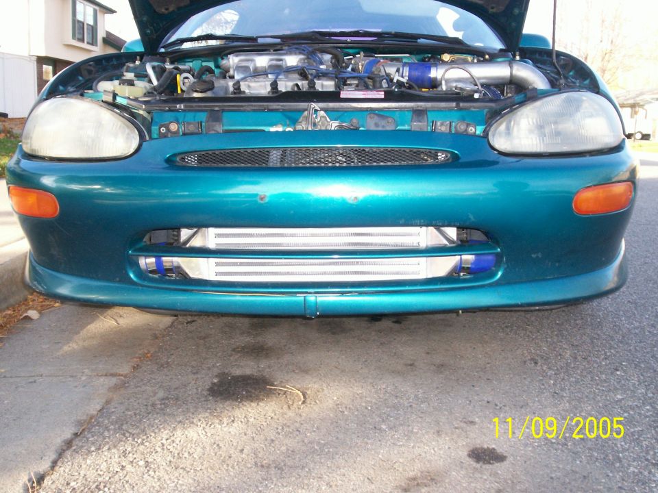 Teal 1994 Mazda MX-3 front view with hood open, showing engine and aftermarket intercooler