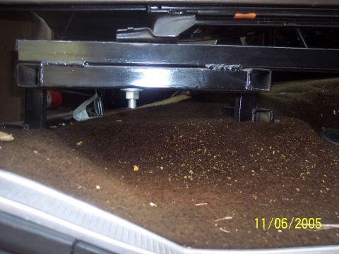 1976 Ford F-150 - Close-up of a vehicle's seat bracket assembly on the floor.