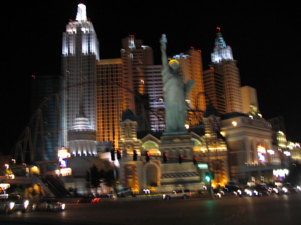 Las Vegas skyline at night with Statue of Liberty replica and buildings illuminated