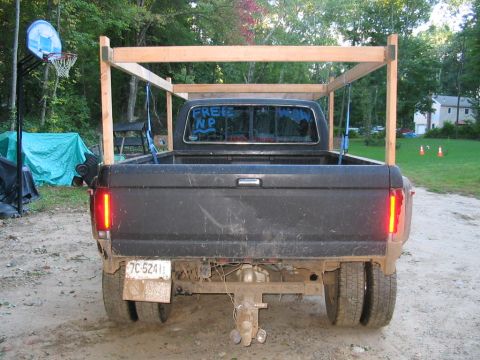 1985 Ford F-350 - Rear view of a 1985 Ford F-350 pickup truck, equipped with a wooden rack and dual rear wheels.