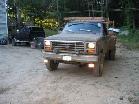 1985 Ford F-350 - This 1980s Ford F-350 dually truck, seen from the front, appears to be a work in progress with a wooden rack mounted on top.