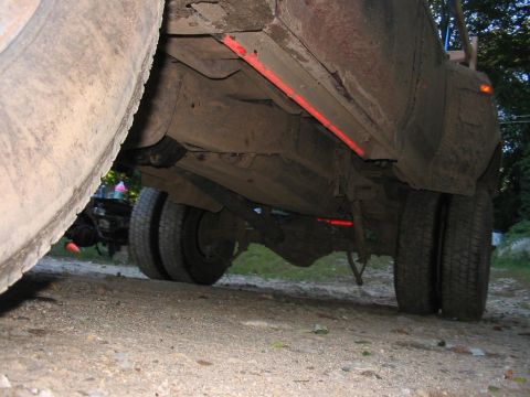 1985 Ford F-350 - Close-up of a dually truck's undercarriage, focusing on the rear axle and wheels.