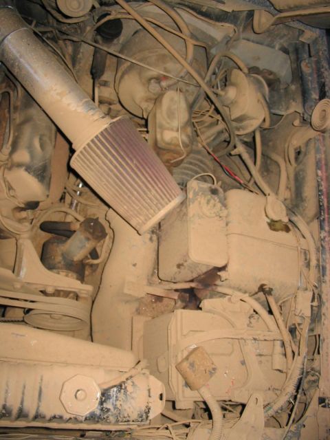 1985 Ford F-350 - The engine bay is heavily covered in dust, obscuring most details and making year identification impossible.