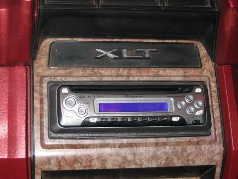 1985 Ford F-350 - Close-up of the interior dashboard showing the XLT trim badge and a Pioneer stereo system in a 1985 Ford F-350.