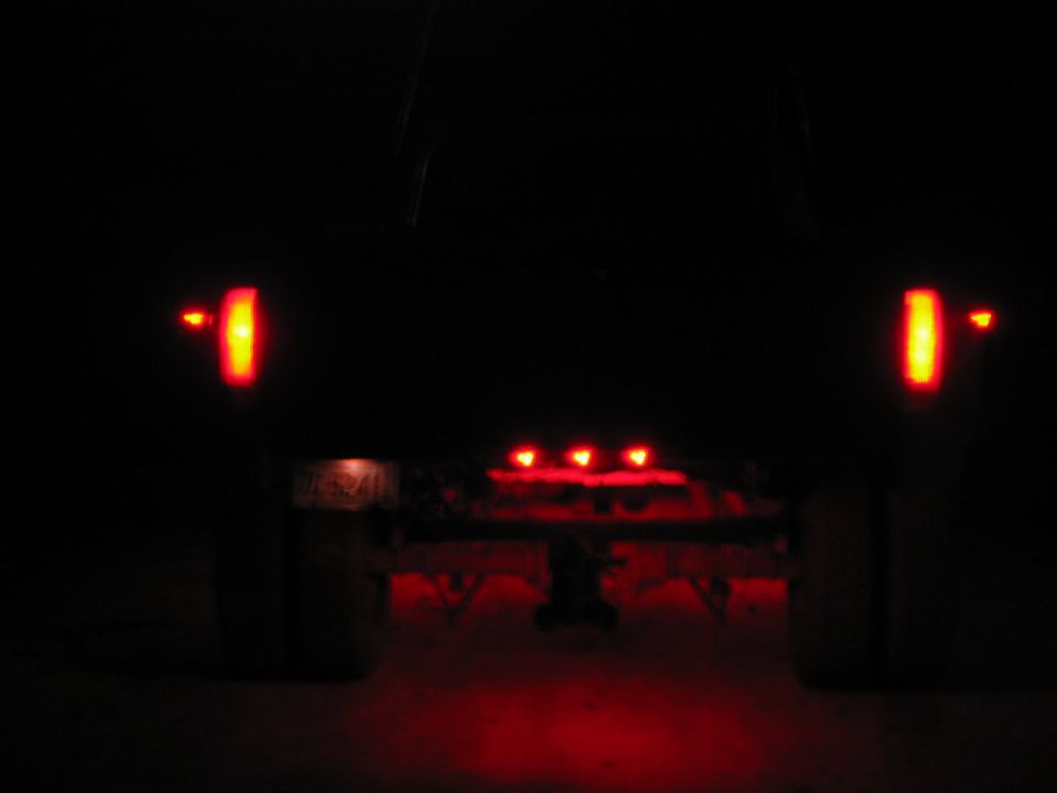 Rear of truck with red brake lights and cab lights illuminated