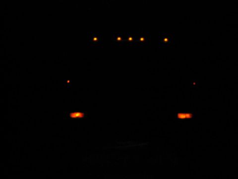 1985 Ford F-350 - Illuminated cab marker lights on a 1985 Ford F-350 at night.