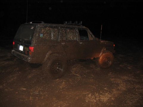 1985 Ford F-350 - This heavily mud-splattered SUV is seen off-road at night, equipped with a roof rack.