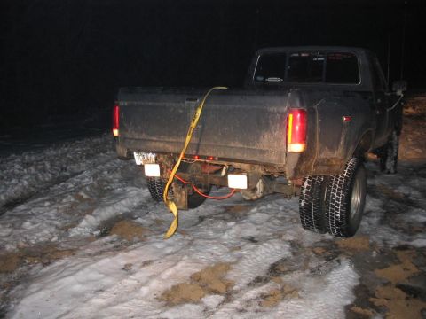 1985 Ford F-350 - A dually pickup truck, likely from the early 1980s, is parked in a snowy area with a yellow strap secured across its bed.