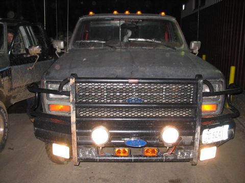 1985 Ford F-350 - This truck features a heavy-duty brush guard and multiple lights, suggesting it's used for off-road or work purposes.