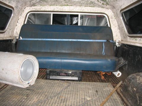 1985 Ford F-350 - Interior view of a pickup truck bed, equipped with a bench seat and audio system.