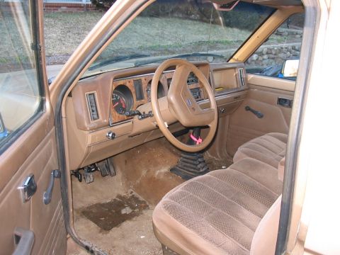1988 Ford Ranger - Interior view of a 1988 Ford Ranger, showing the tan dashboard, steering wheel, and seats.