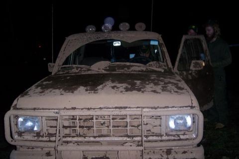 1988 Ford Ranger - This 1988 Ford Ranger is covered in mud, with its front grille and headlights clearly visible.
