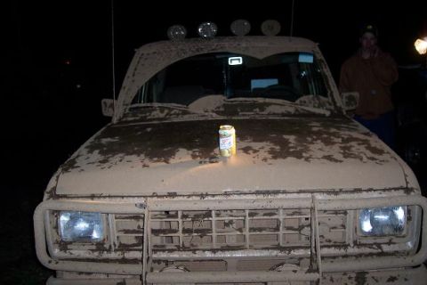 1988 Ford Ranger - Mud-covered 1988 Ford Ranger front end with a can of soda on the hood at night.