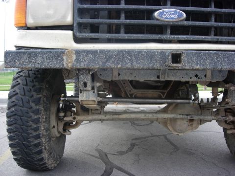 1987 Ford Bronco - Close-up of the front axle and suspension on a 1987 Ford Bronco, a hi-steer modification.