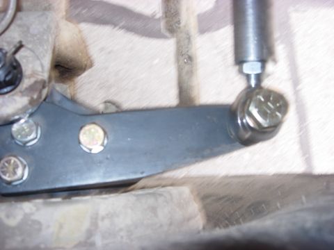 1987 Ford Bronco - Detail of a vehicle's steering linkage system, showing a custom arm and hardware.