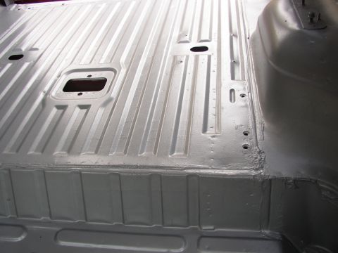 1995 Ford Bronco - Vehicle floor pan with ribbed metal texture and mounting holes.