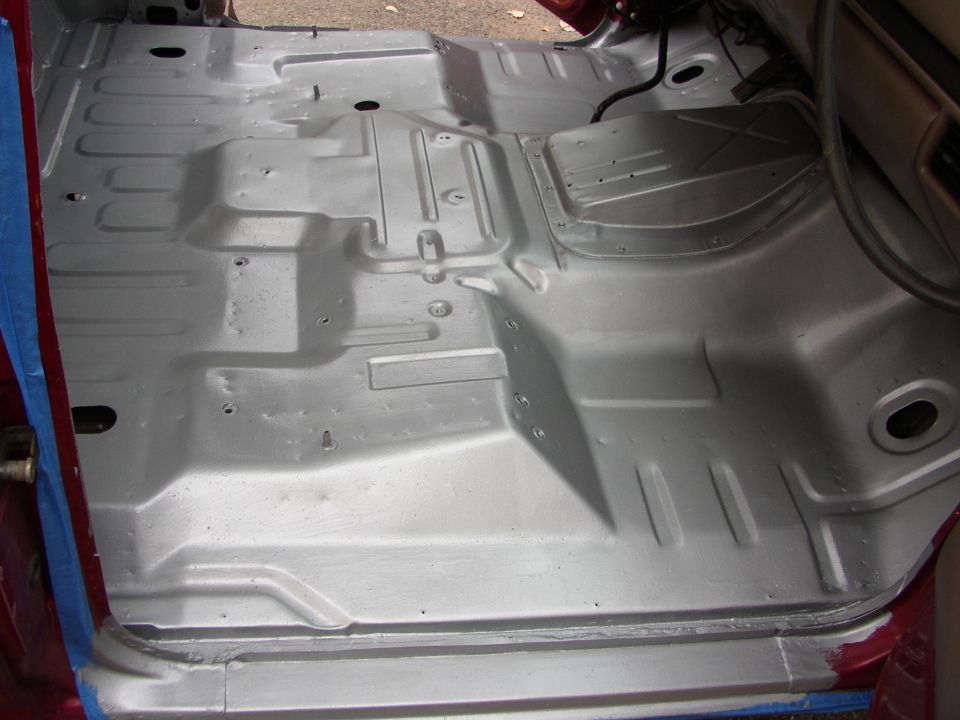 Silver painted interior floor pan with visible structural ribs and bolt holes