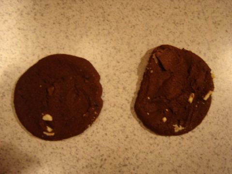 1999 Ford Taurus - Two chocolate chip cookies sit on a speckled countertop. The bottom right corner has a "SUPERMOTORS" watermark.