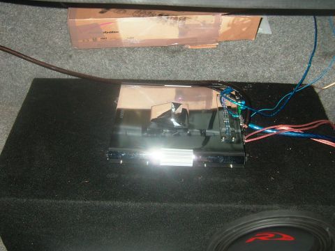 1992 Ford Crown Victoria - Car audio equipment, including an amplifier and subwoofer, is installed in the trunk of a vehicle.