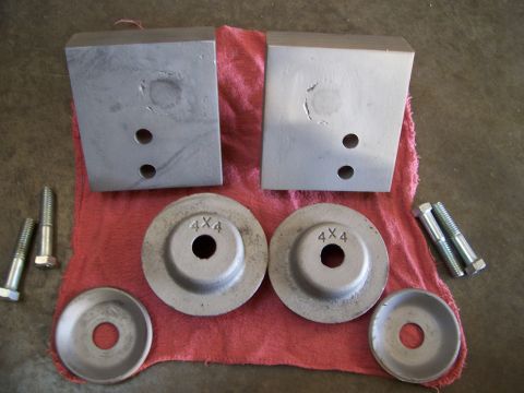 1983 Ford Bronco - Aftermarket suspension lift blocks and hardware are laid out on a red cloth.