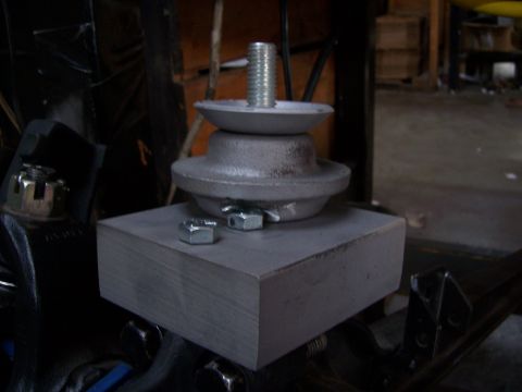 1983 Ford Bronco - Close-up of an engine mount assembly, showing a bolt, washer, and nuts.