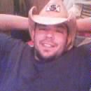 1986 Ford Bronco - A man in a cowboy hat relaxes with his hands behind his head.