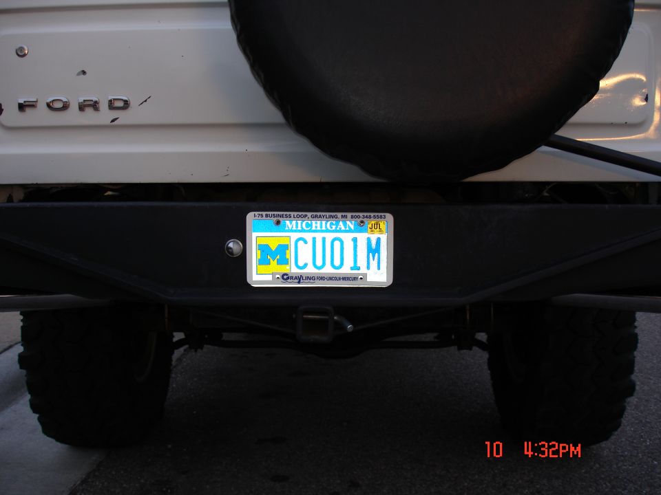 White Ford Bronco rear bumper with a Michigan license plate and a spare tire mounted above