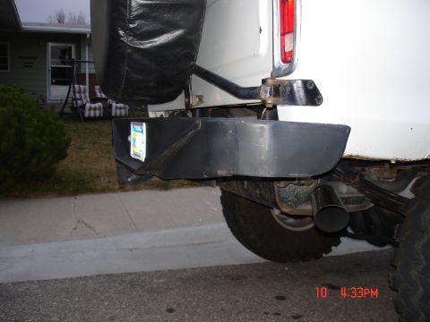 1979 Ford Bronco - Rear view of a 1979 Ford Bronco, showing the bumper, spare tire cover, and a license plate.
