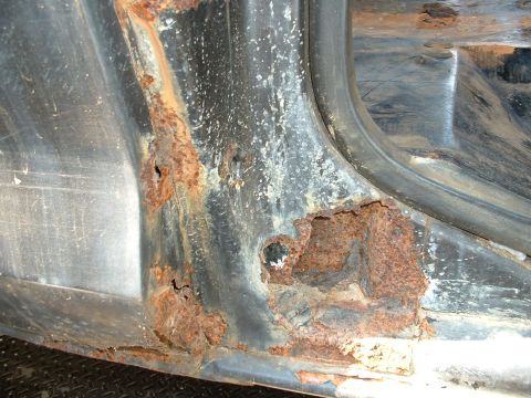 1978 Ford Bronco - This image shows severe rust damage on a vehicle's door frame, obscuring any specific year identification.